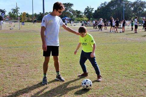 TopSoccer volunteer Eric Ehrnst helps his "buddy" Jordan Ogman learn soccer