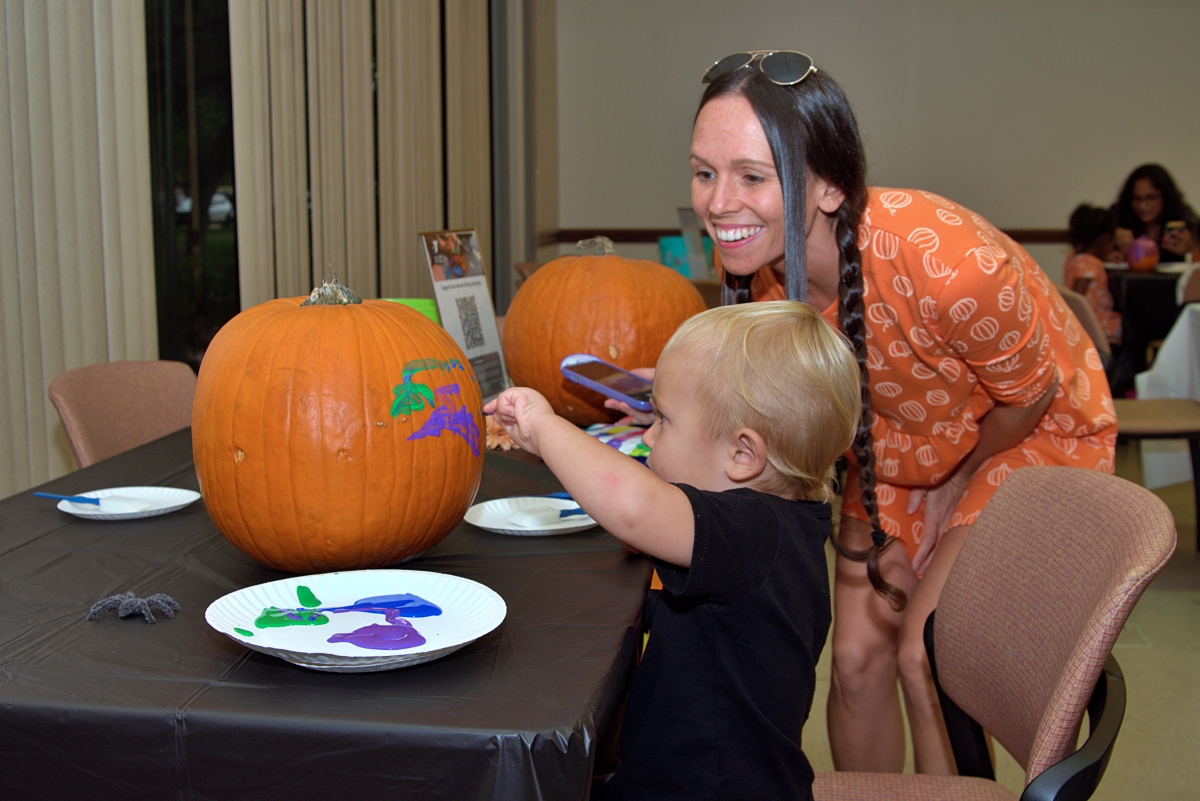 Mom smile when helping paint pumpkin