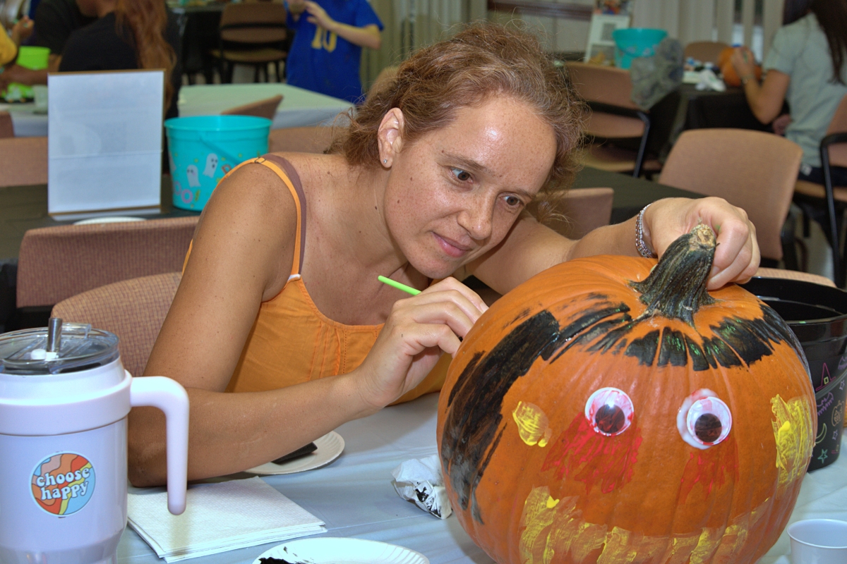 Woman painting her pumpkin