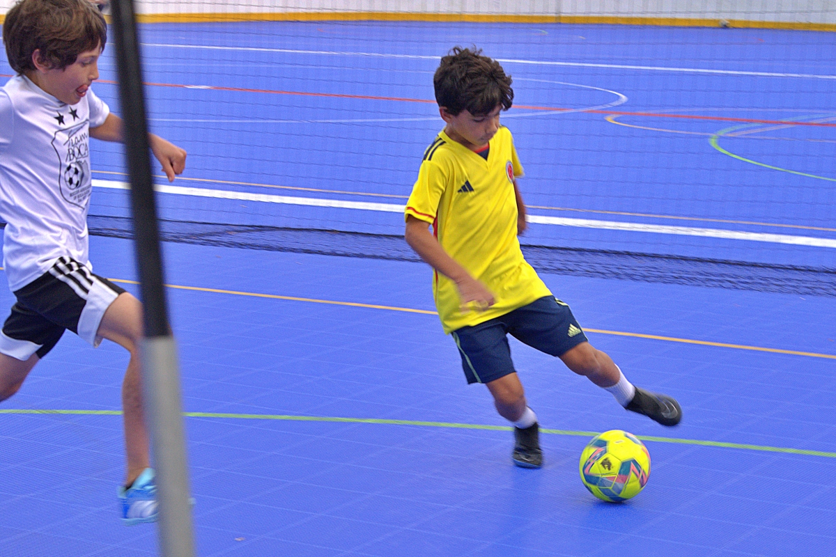 Mason Meyer charges David Mightingale during futsal play.