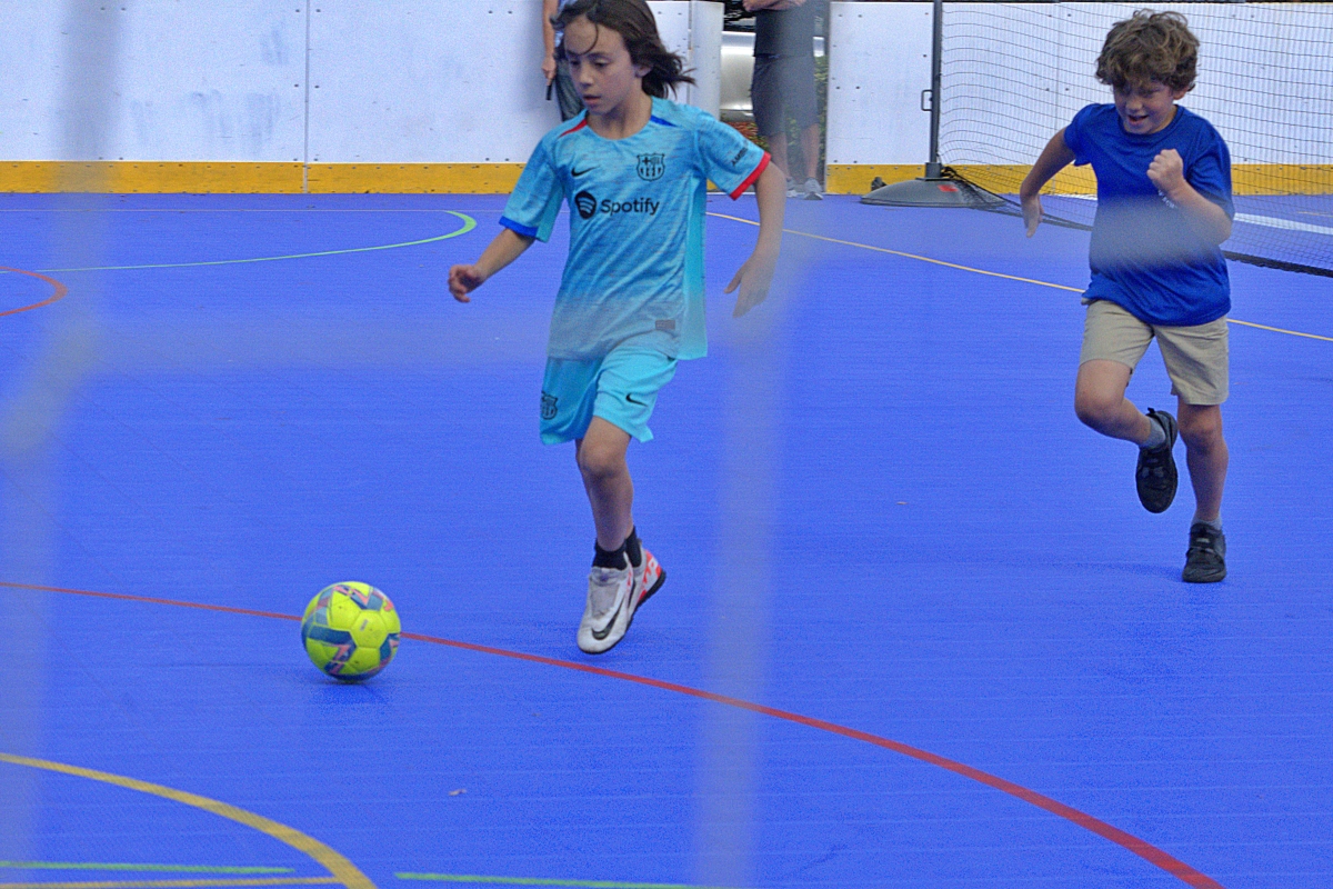 Leo Dutu chases Milan Castro during futsal practice.