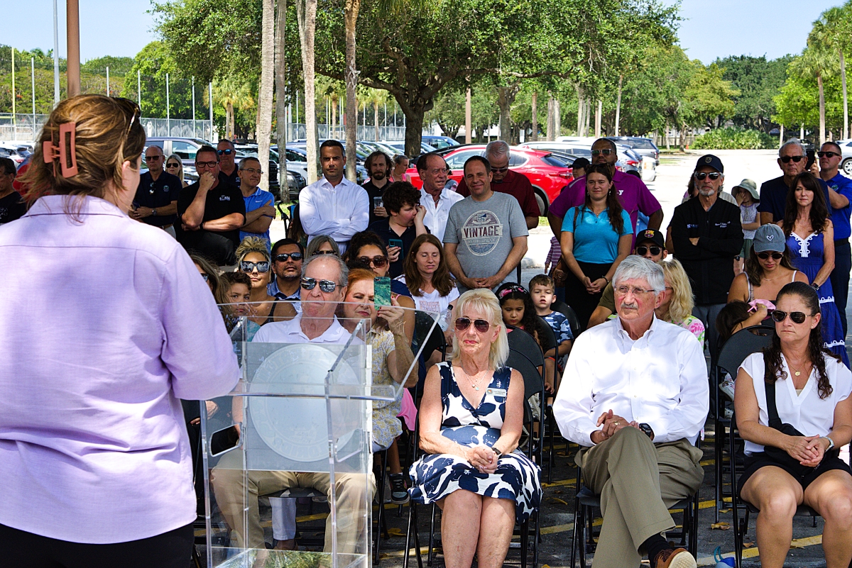 District Executive Director Briann Harms addresses the large crowd that gathered for the playground ribbon cutting