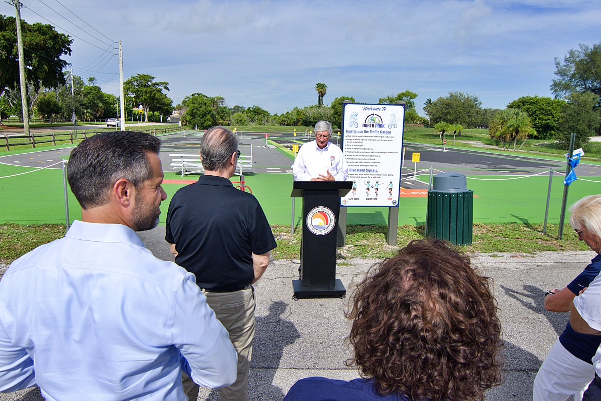 District Commissioners Bob Rollins addresses the crowd at the Traffic Garden ribbon cutting ceremony.