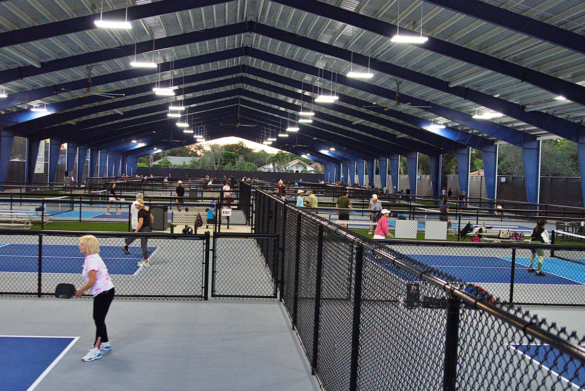 Patch Reef Park's covered pickleball courts are packed at night.
