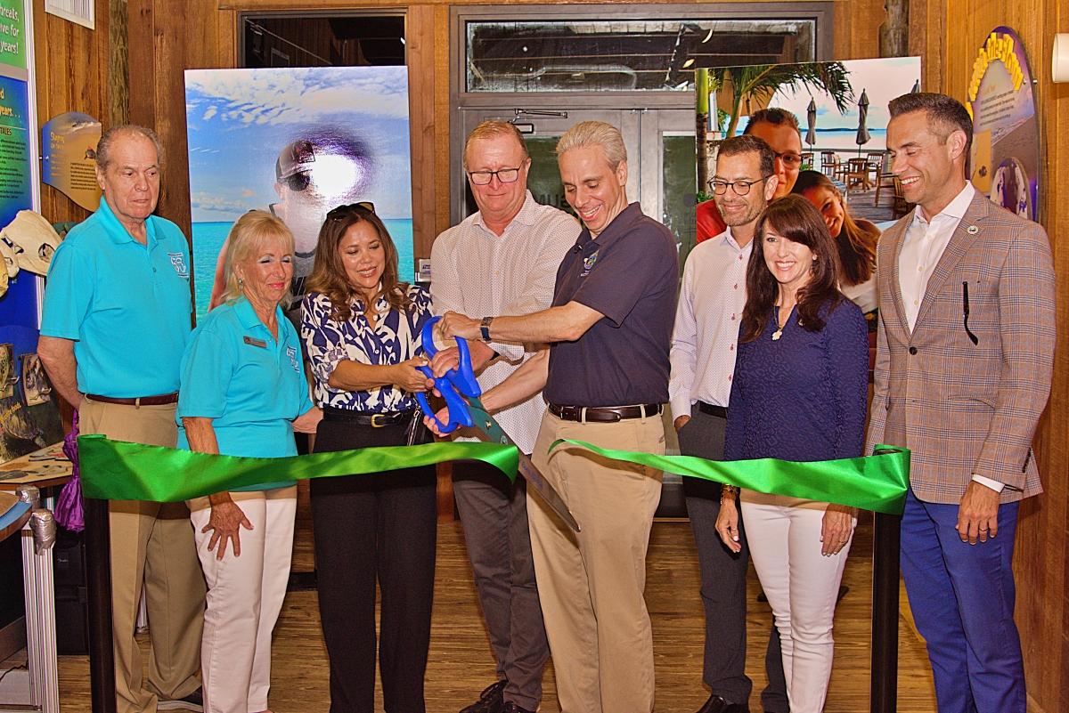 Surrounded by Commissioners from the Greater Boca Raton Beach and Park District and members of the Boca Raton city council, Boca Raton Mayor Scott Singer and Jacob Kosowsky's mother Sharilyn Jones ceremoniously open Jacob's Outlook by cutting the ribbon. 