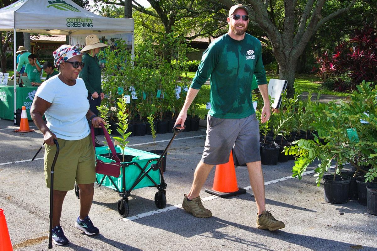 Josh from Community Greening helping wheel away a tree