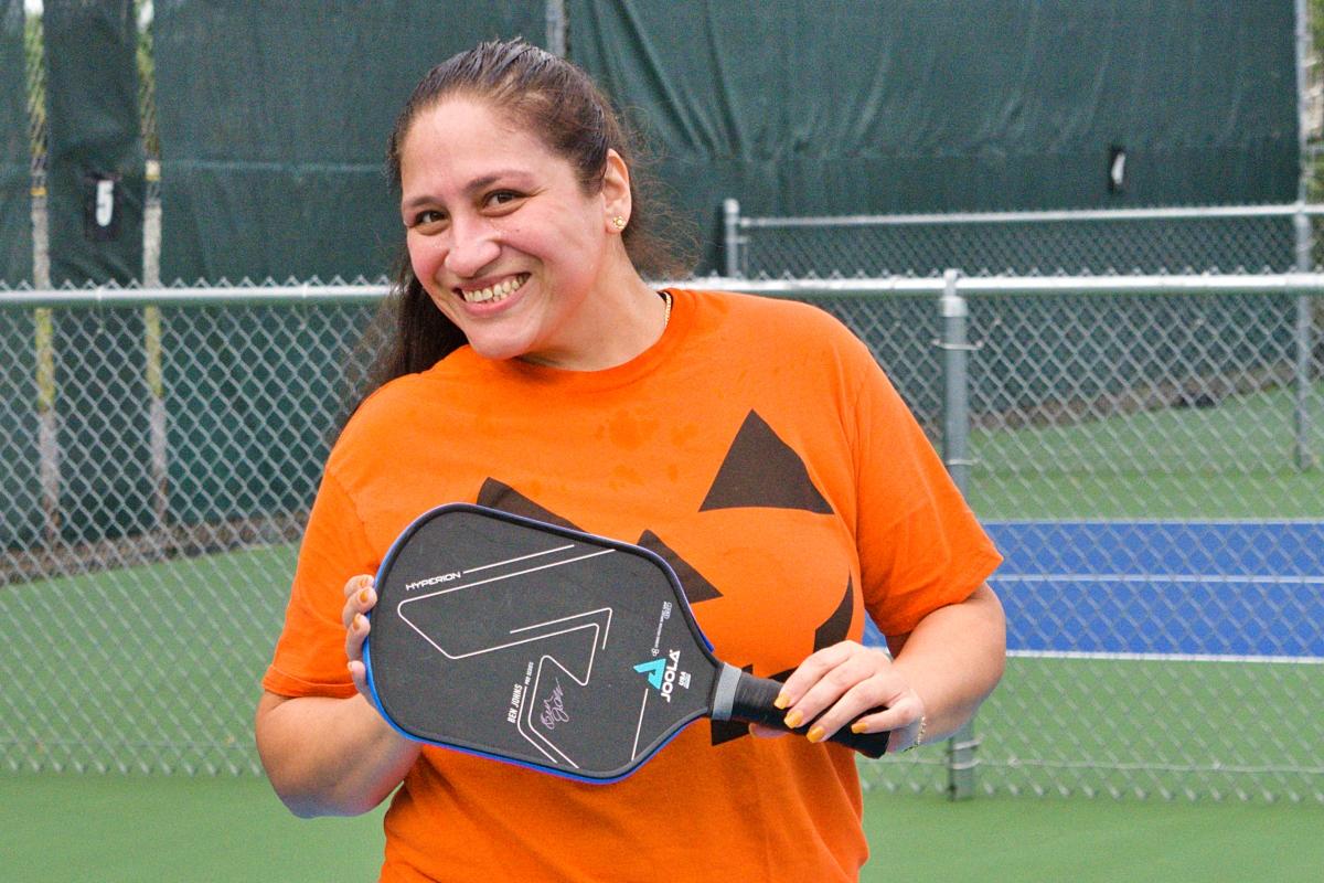 Smiling while wearing a pumpkin shirt