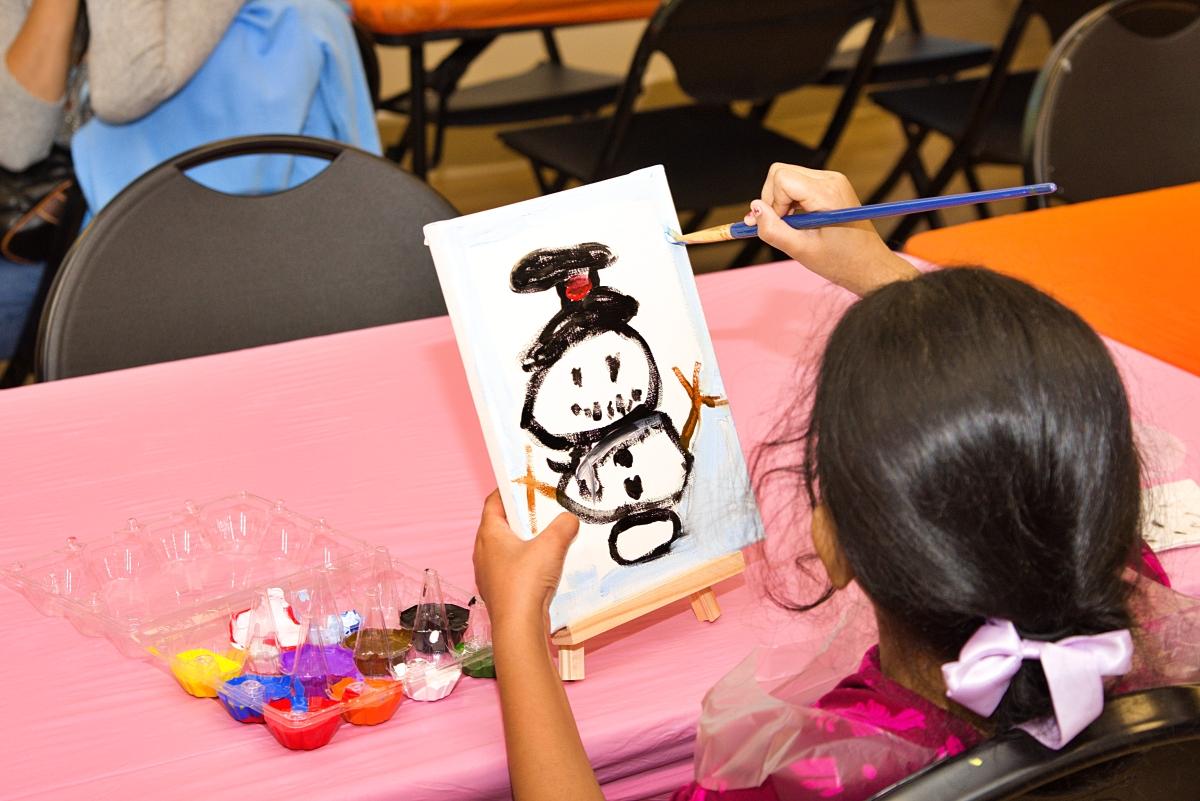 girl painting snowman