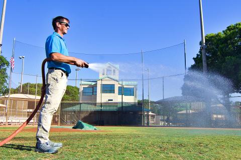 Jim Gannon watering Sugar Sand baseball field