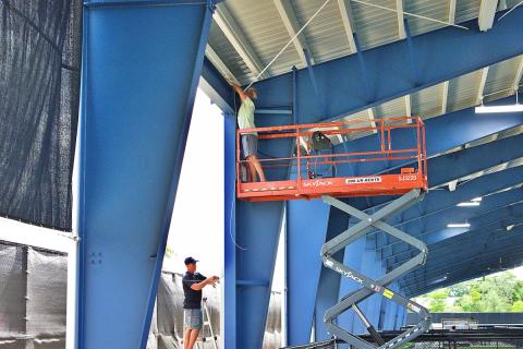 Workers installing glare-reduction screen
